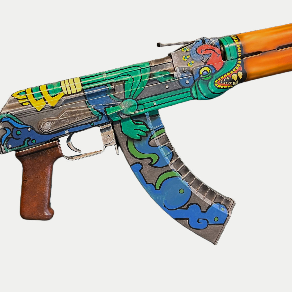 Detail of the AK-47 Fire Serpent receiver and magazine, showing yellow rear markings, silver-grey edges, green serpent and red-brown grip.