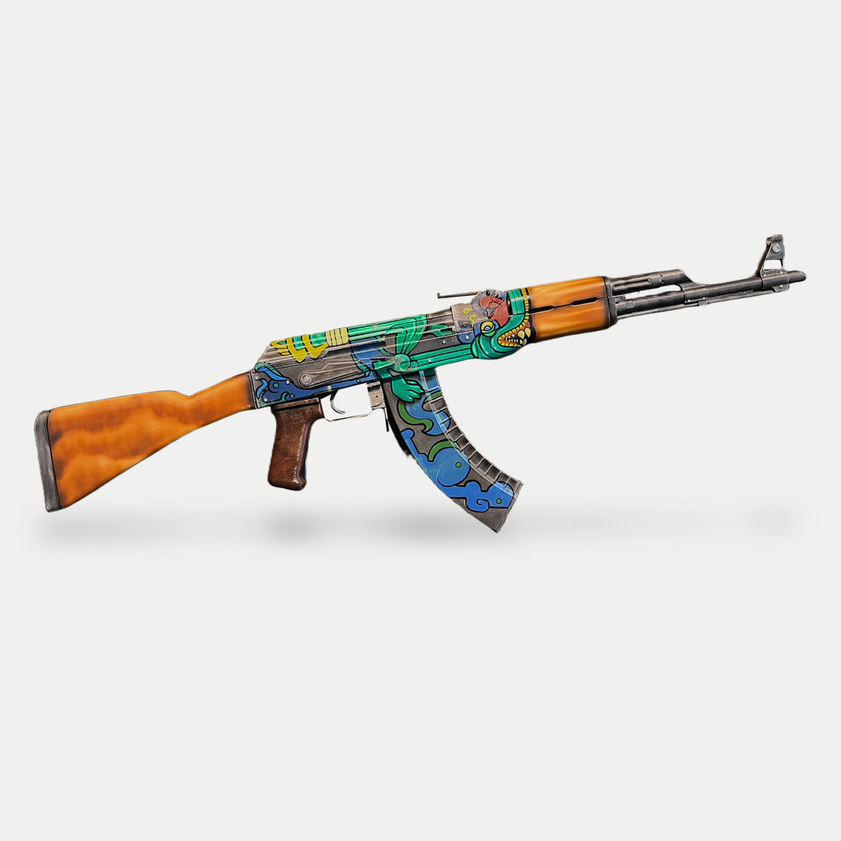 Opposite side of the AK-47 Fire Serpent prop, muzzle right, showing the green serpent, yellow receiver markings and blue cloud magazine.
