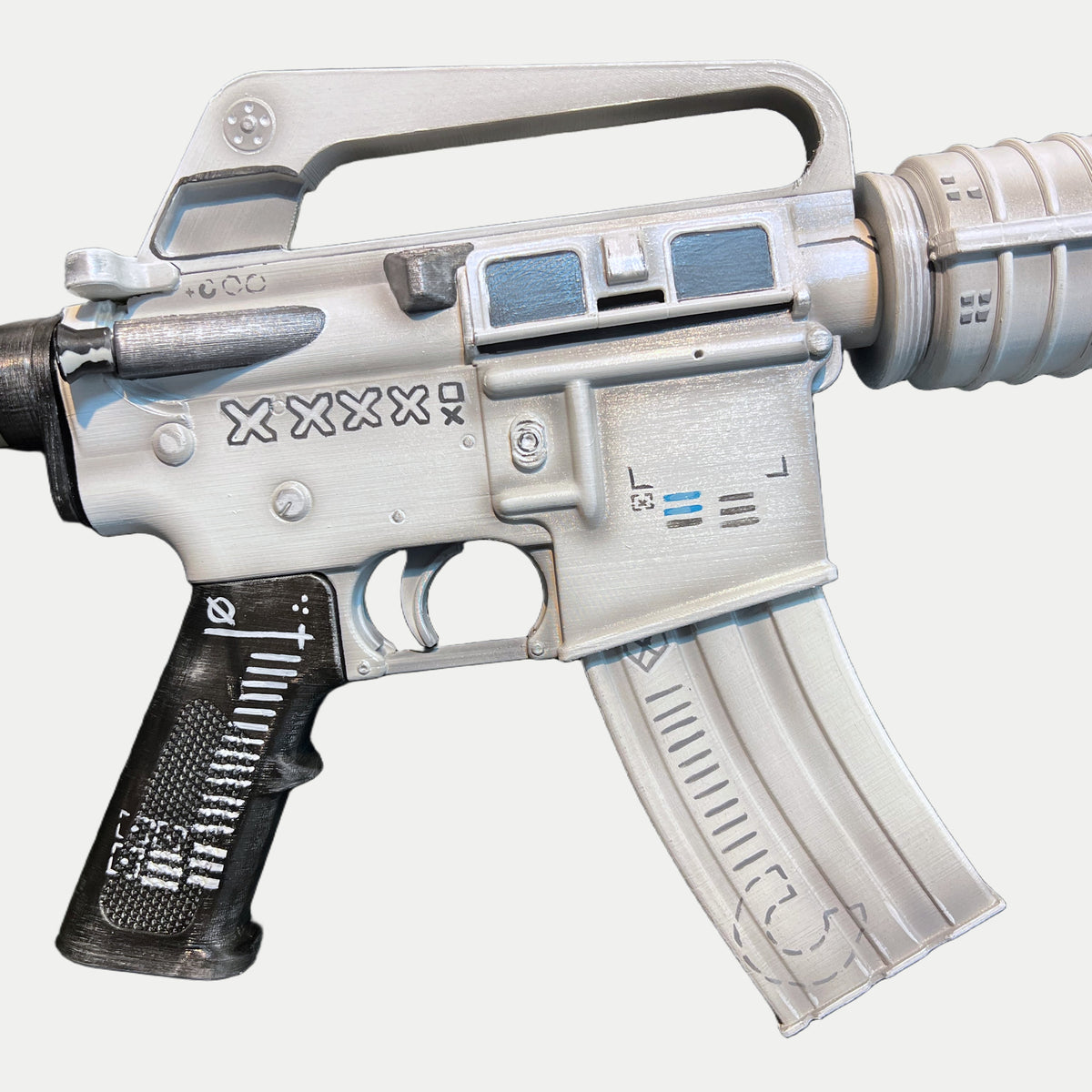 Receiver of the CS2 M4A1-S Printstream prop from the ejection port side, XXXX lettering above the magazine well and the black grip