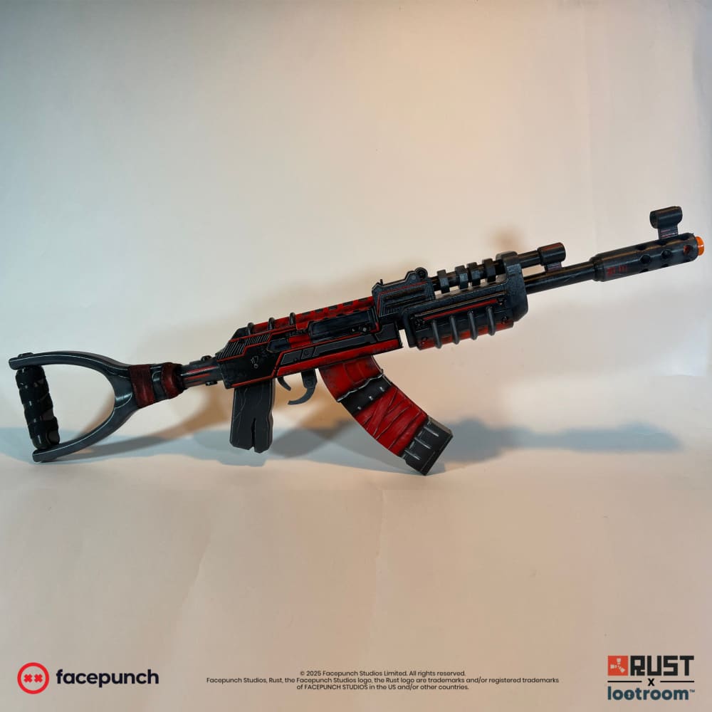 Rust Alien Red AK prop replica in full side view, black body with red panels and shoulder stock attached