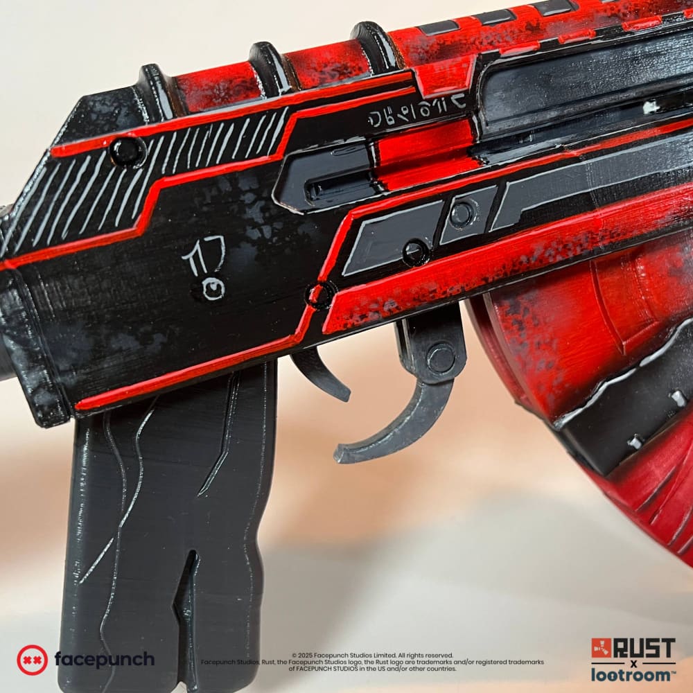 Close-up of the Alien Red AK receiver with alien glyphs, red contour lines and the red speckled magazine