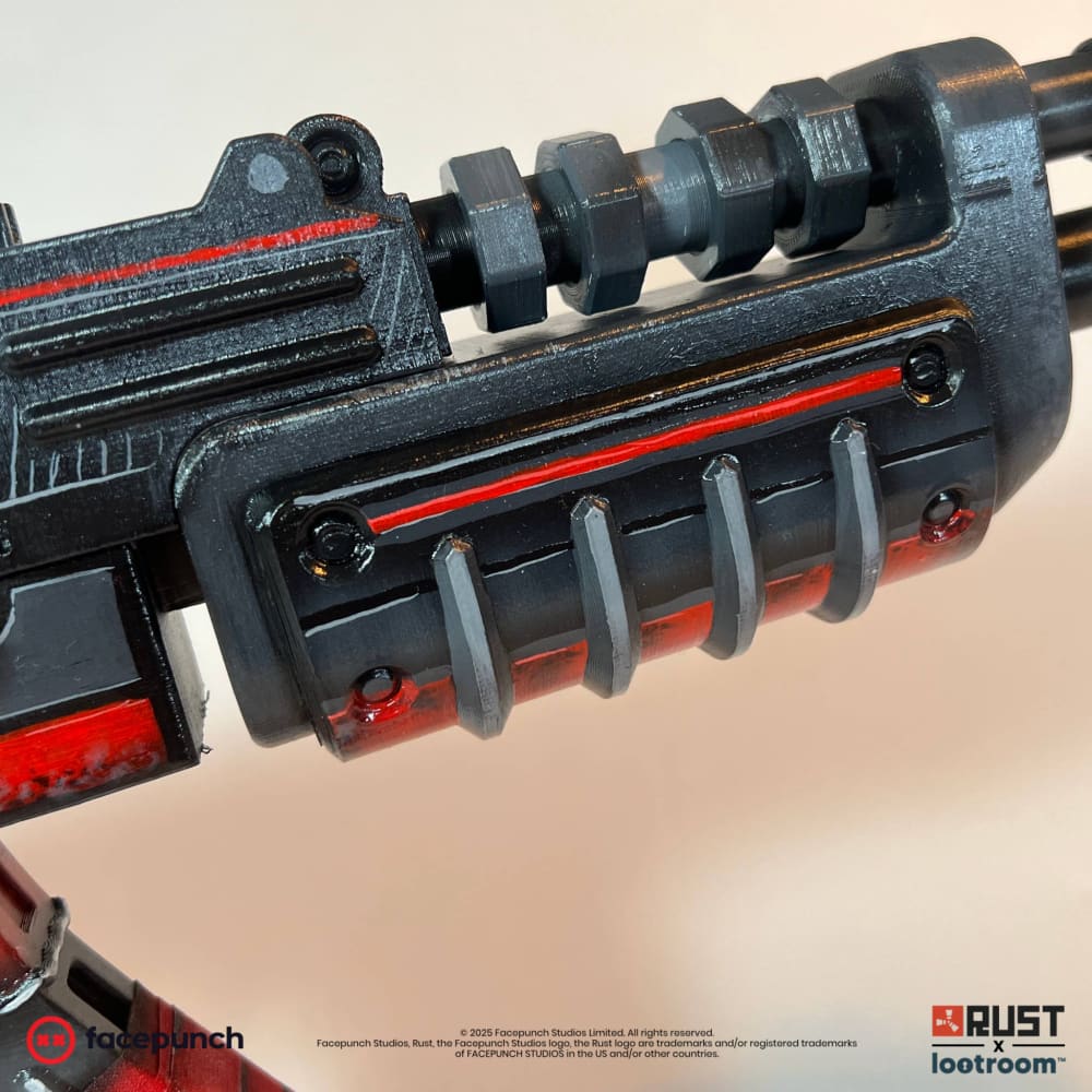 Handguard and barrel of the Rust Alien Red AK prop, black with a red stripe and exposed bolts