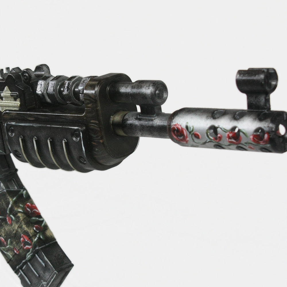 Close-up of the Eltk AK handguard and front end, roses set against the darkened metal.