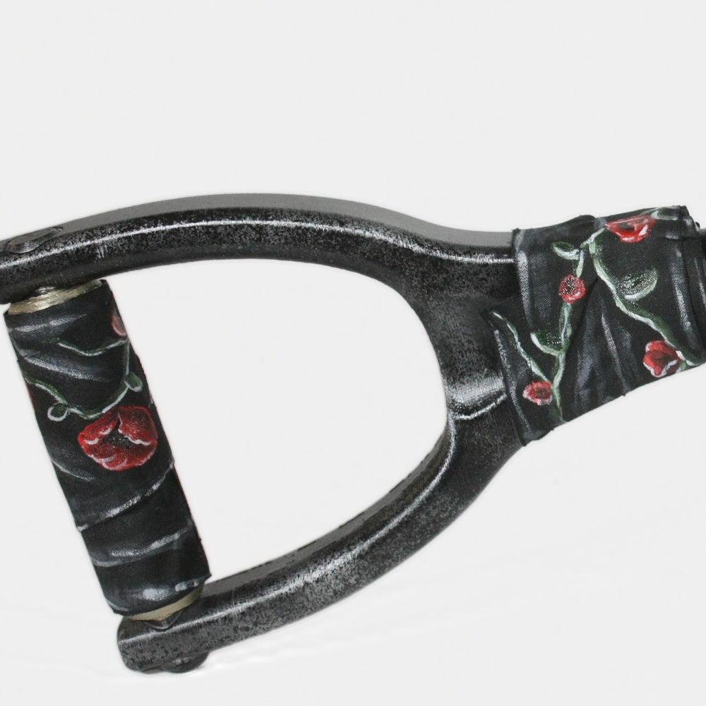 Close-up of the Eltk AK loop stock, roses painted onto the binding wrapped around its neck.
