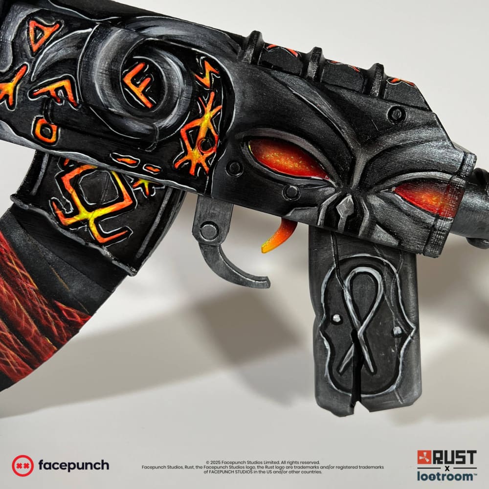 Close-up of the From Hell AK skull, moulded into the receiver with eye sockets glowing orange-red.