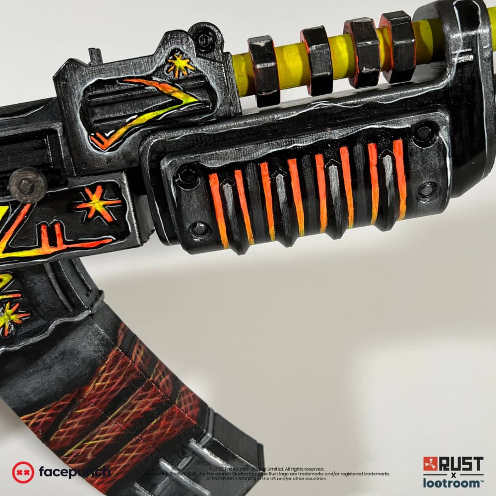 Close-up of the From Hell AK handguard, orange bars over black beside the yellow-green gas tube.
