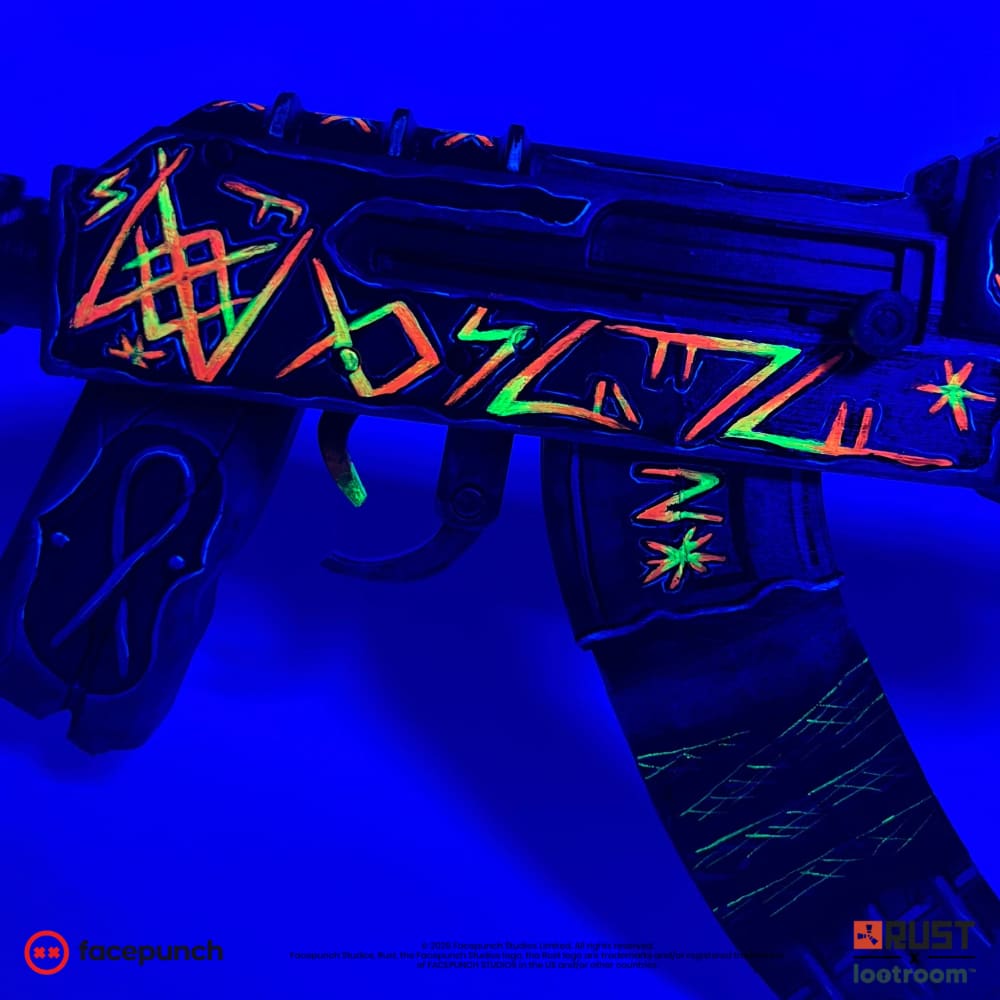 Close-up of the From Hell AK receiver and magazine under UV light, glyphs glowing orange and green.