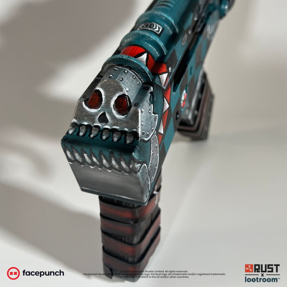 Close-up of the steel skull at the back of the Gearlord AK, red eye sockets over a row of teeth.