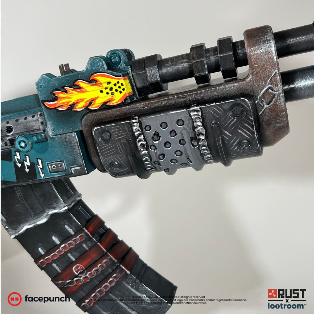 Close-up of the Gearlord AK handguard in bare drilled steel, with the painted flame above it.