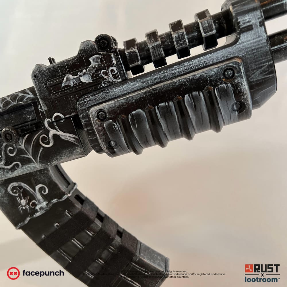 Close-up of the Ghost Halloween AK handguard, a bat above the barrel and a spider on the magazine.