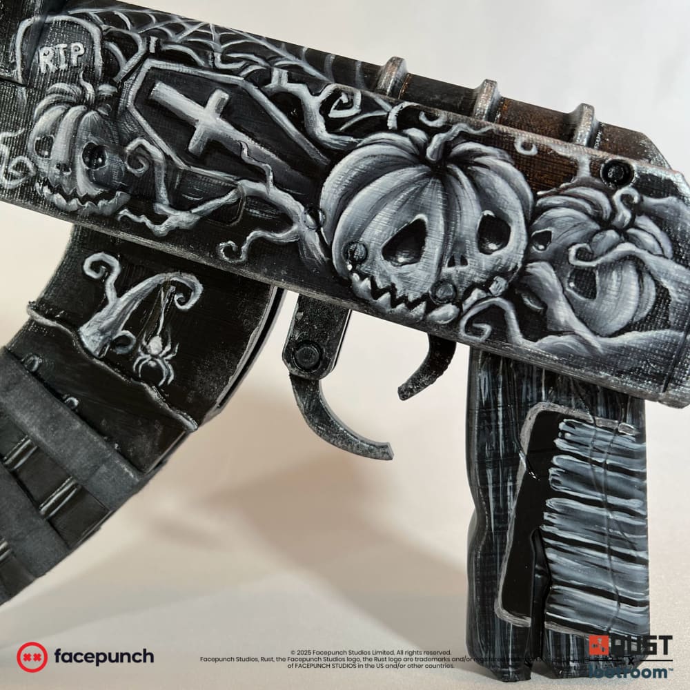 Close-up of the Ghost Halloween AK receiver, a coffin with a cross beside a headstone reading RIP.