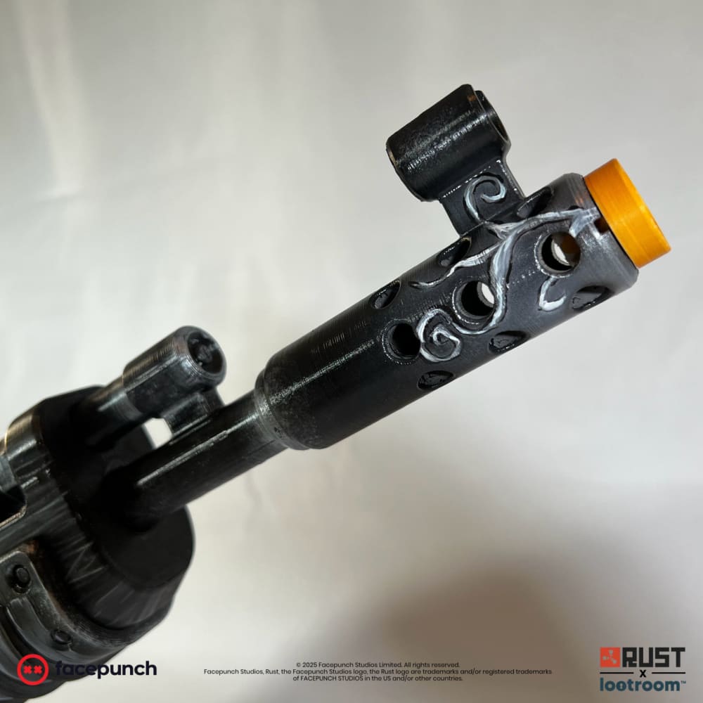 Close-up of the Ghost Halloween AK muzzle end, vines curling across the drilled brake.