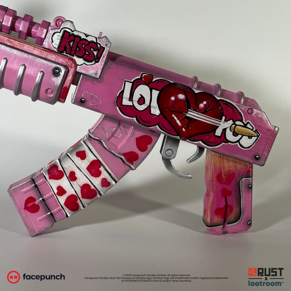 Close-up of the Rust Kiss AK receiver with the LOVE YOU heart pierced by an arrow and the pink grip