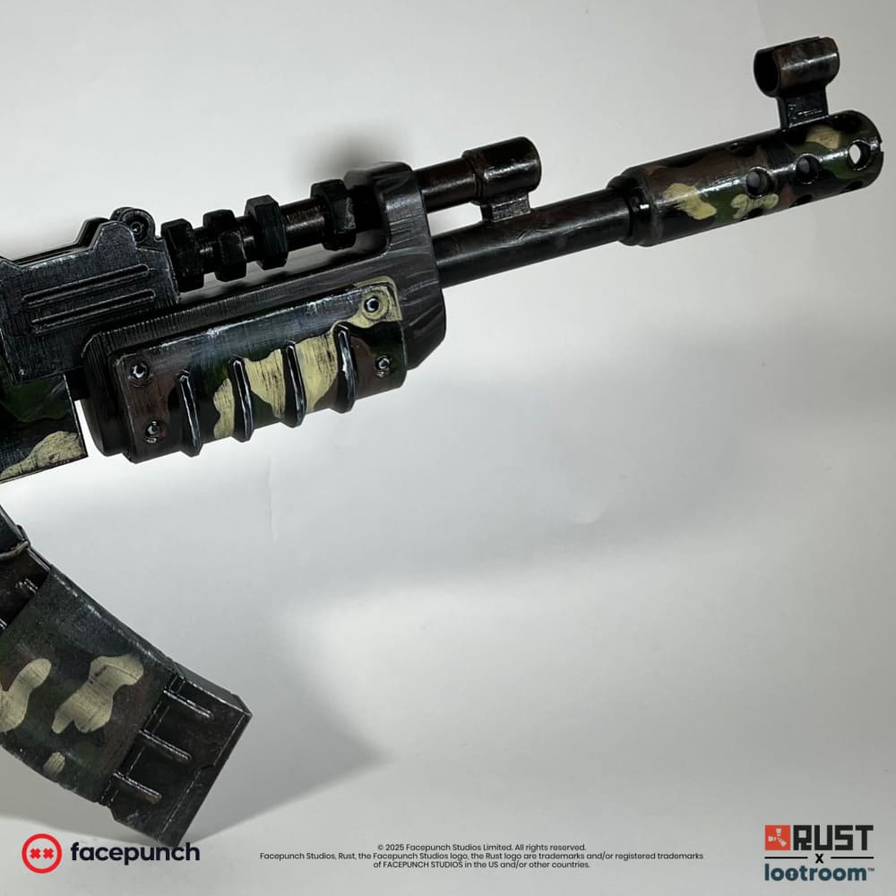Rust Military Camo AK prop at an angle, the camo running out to the muzzle brake and front sight.