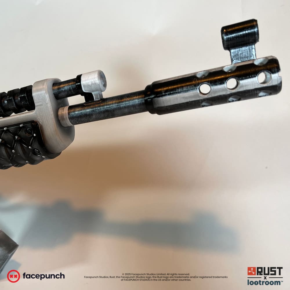 Close-up of the No Mercy AK barrel and front sight, dark steel against a silver gas block.