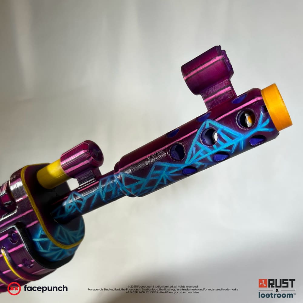 Close-up of the Retrowave AK muzzle brake, cyan wireframe mountains over deep purple.