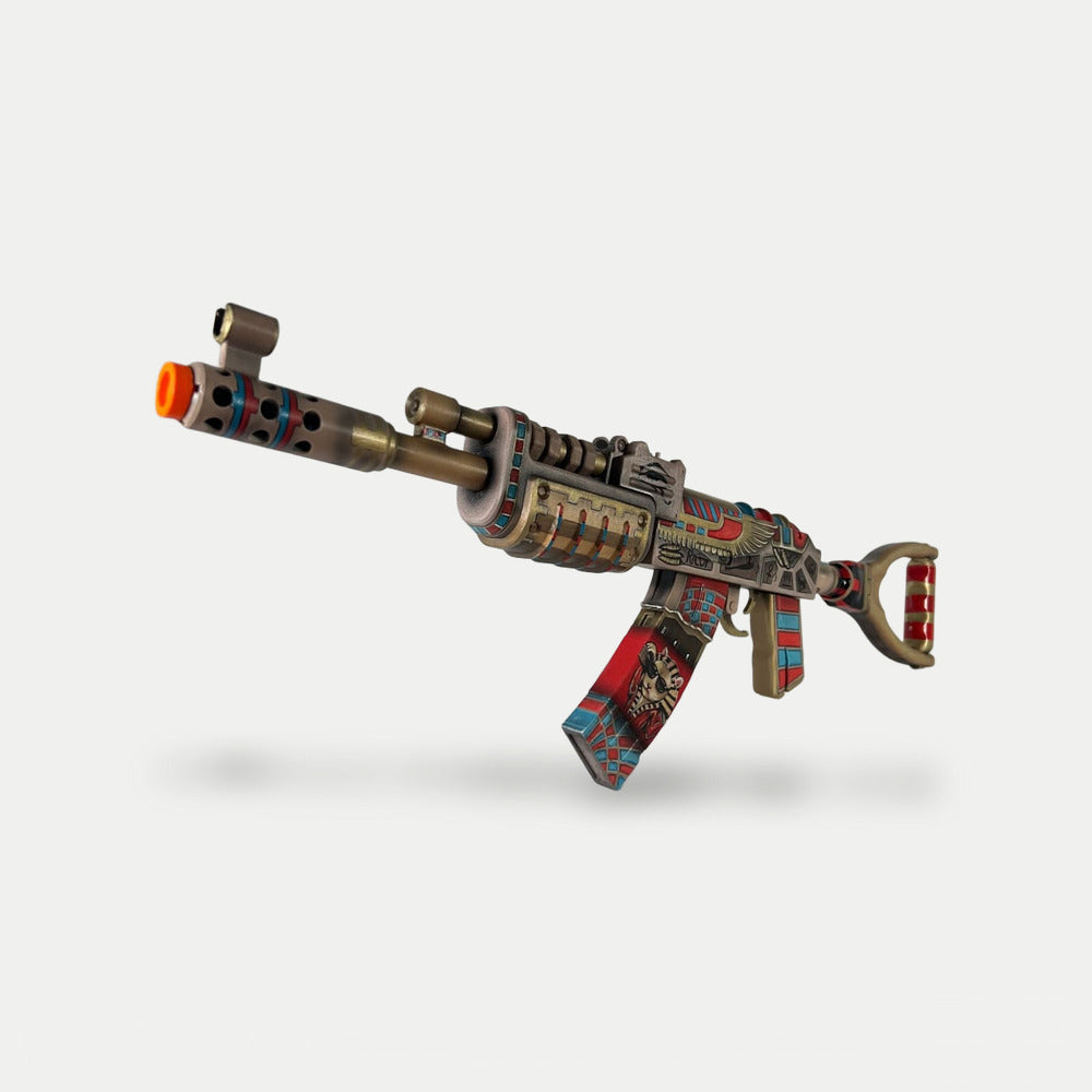 The Ricoy AK prop seen from the muzzle end, gold barrel with turquoise and red rings.