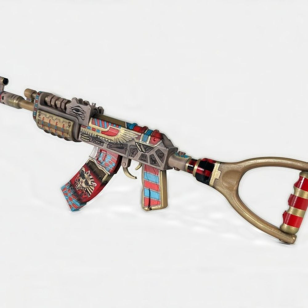 The Ricoy AK prop at an angle from the stock end, gold base under red and turquoise patterns.