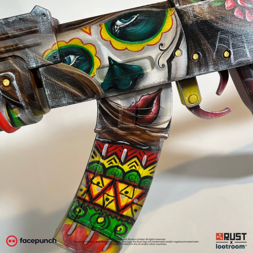 Close-up of the Santa Muerte AK receiver, teal eyes ringed in yellow and red above red lips.