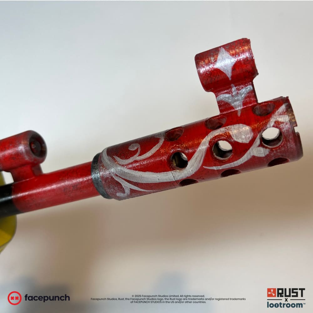 Close-up of the Santa Muerte AK muzzle, red with white scrollwork painted over it.
