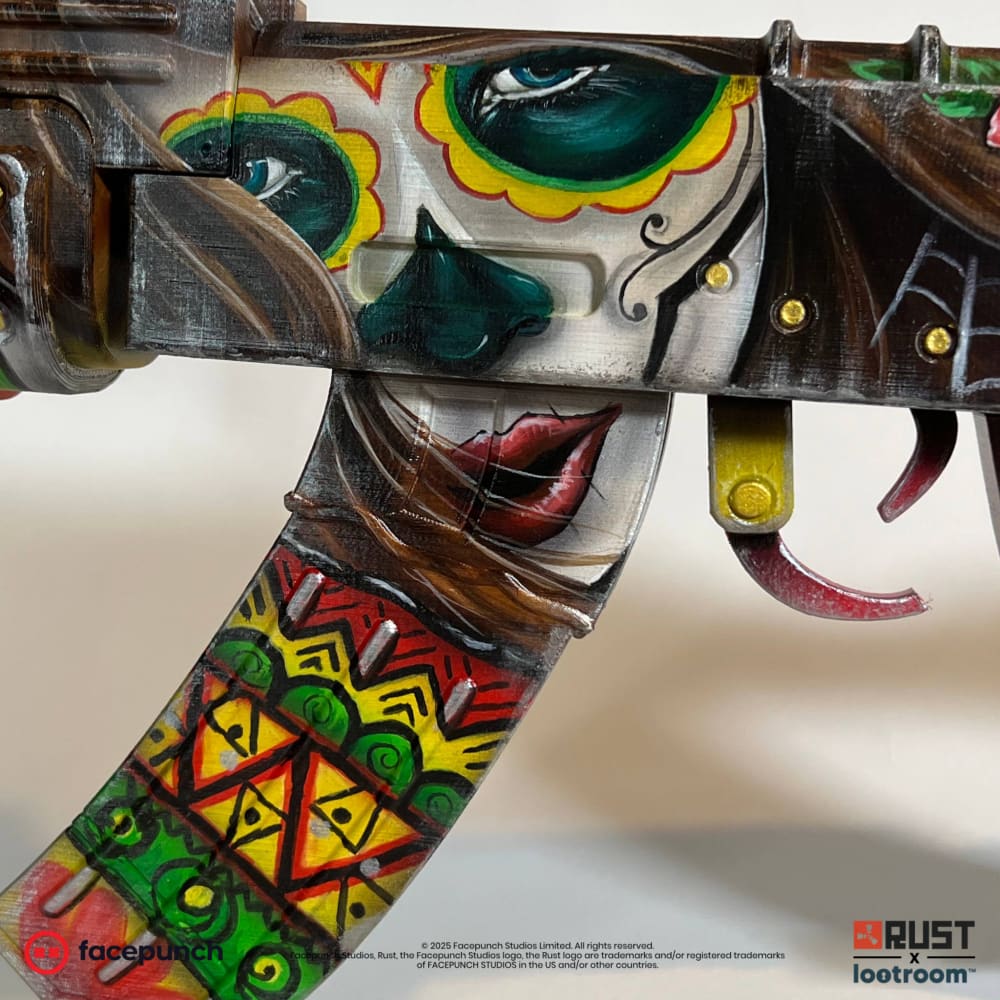 Close-up of the Santa Muerte AK magazine, a band of red, yellow and green zigzags below the painted lips.