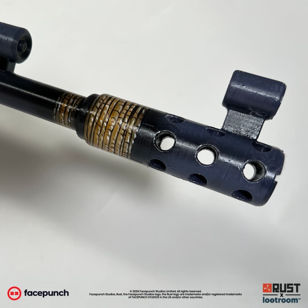 Close-up of the Ser Winter AK muzzle, a painted gold cord wrapped around the barrel.