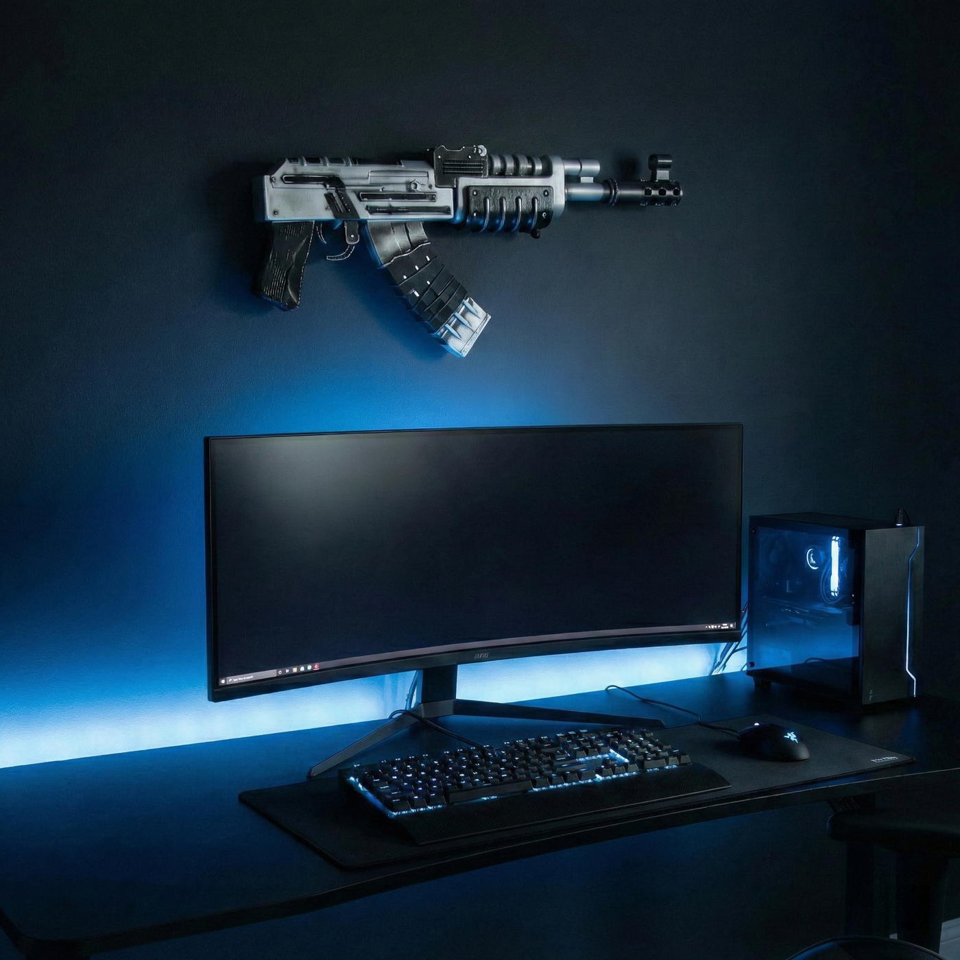 Rust Tacularr AK prop displayed in a gaming room above a desk setup