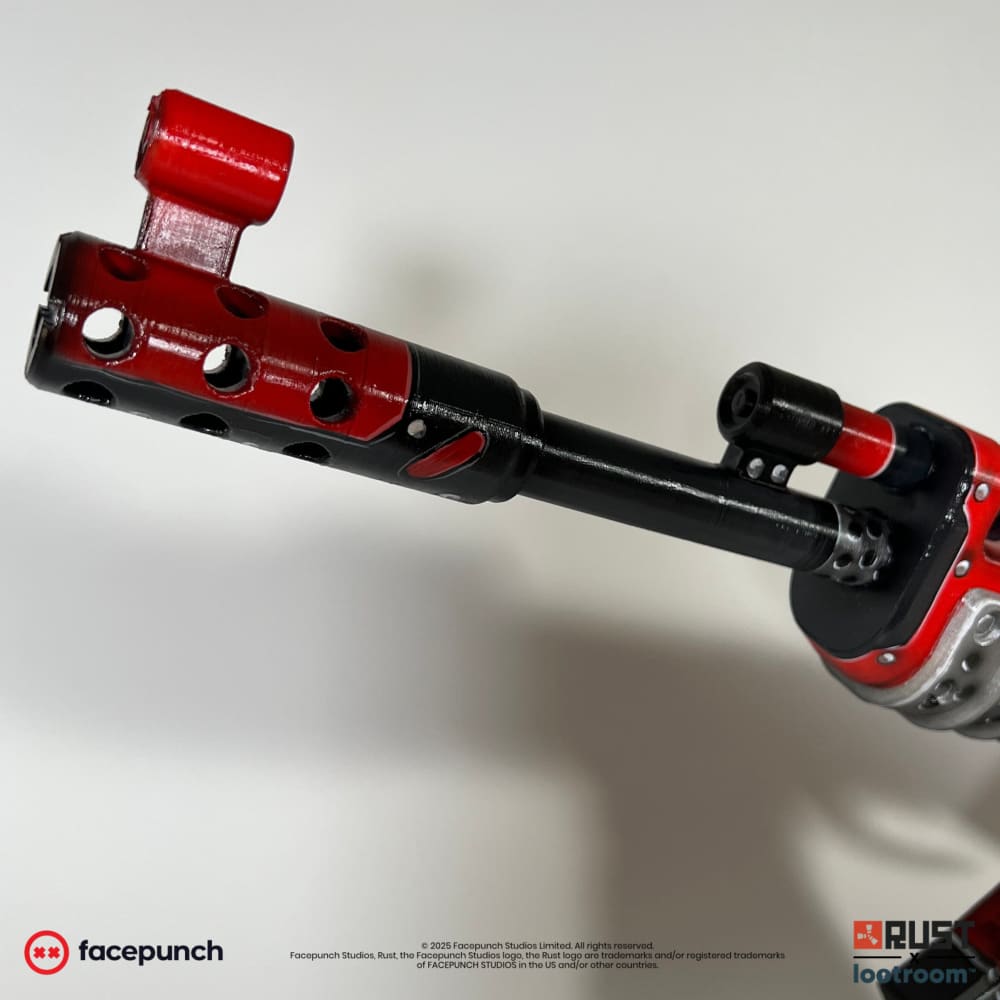 Close-up of the Team Rocket AK muzzle brake in red and black.
