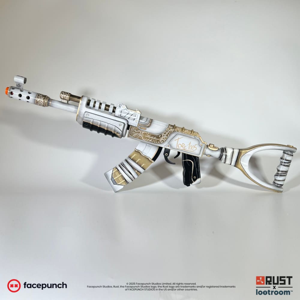 Rust Tore1005 AK prop from the other side, white with gold bands on the magazine.