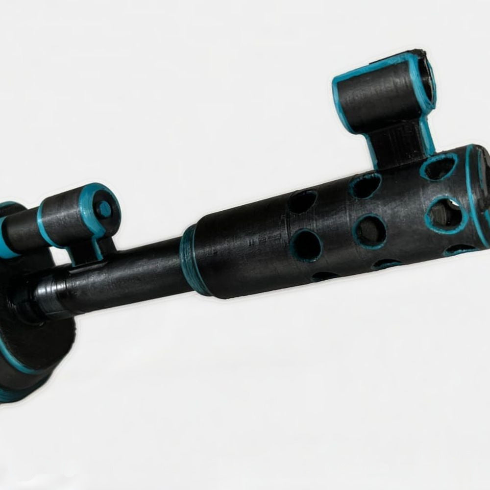 Close-up of the xQc AK muzzle brake, matte black with cyan around the ports.