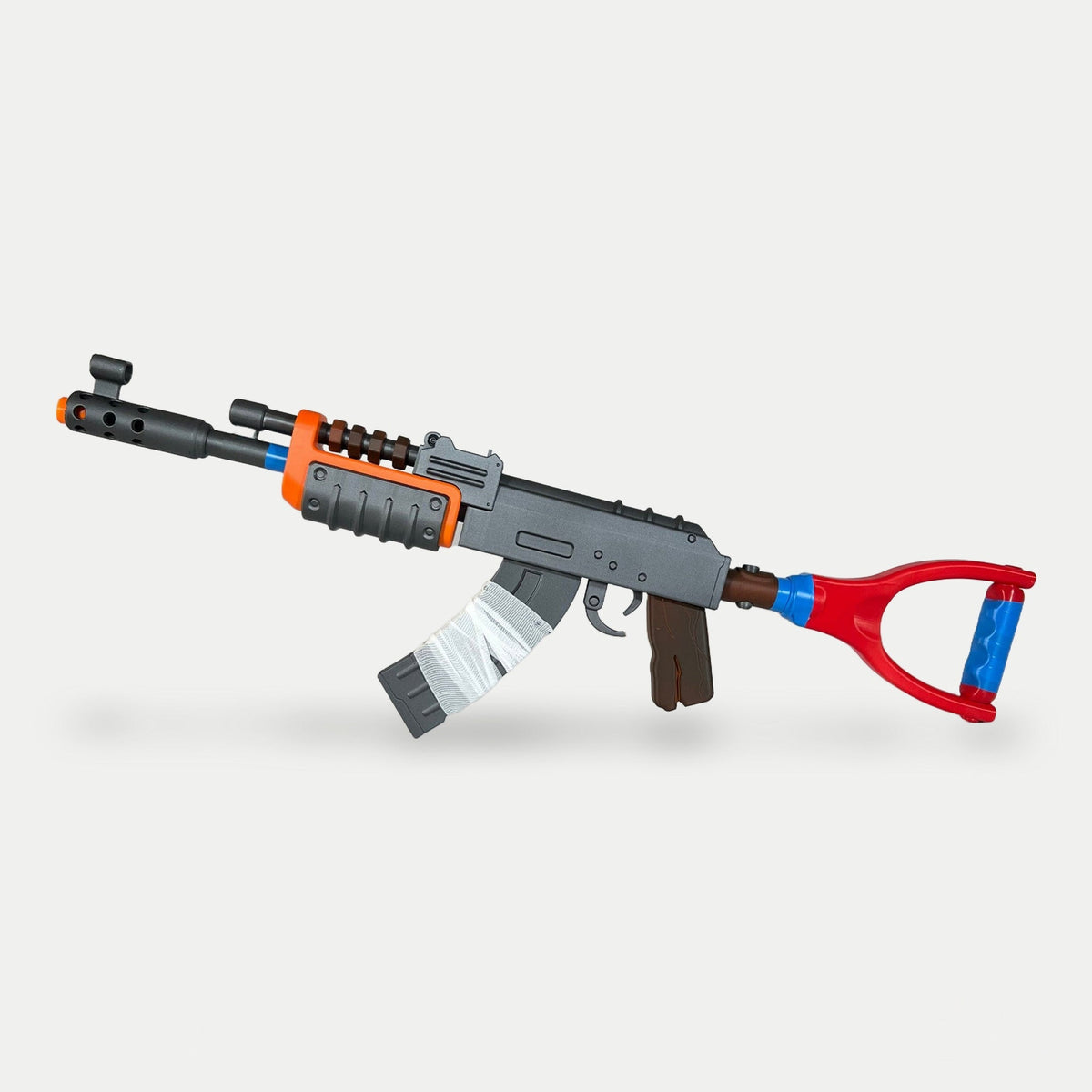 The Rust AK prop from the kit from the opposite side, showing the orange handguard and wood-effect grips