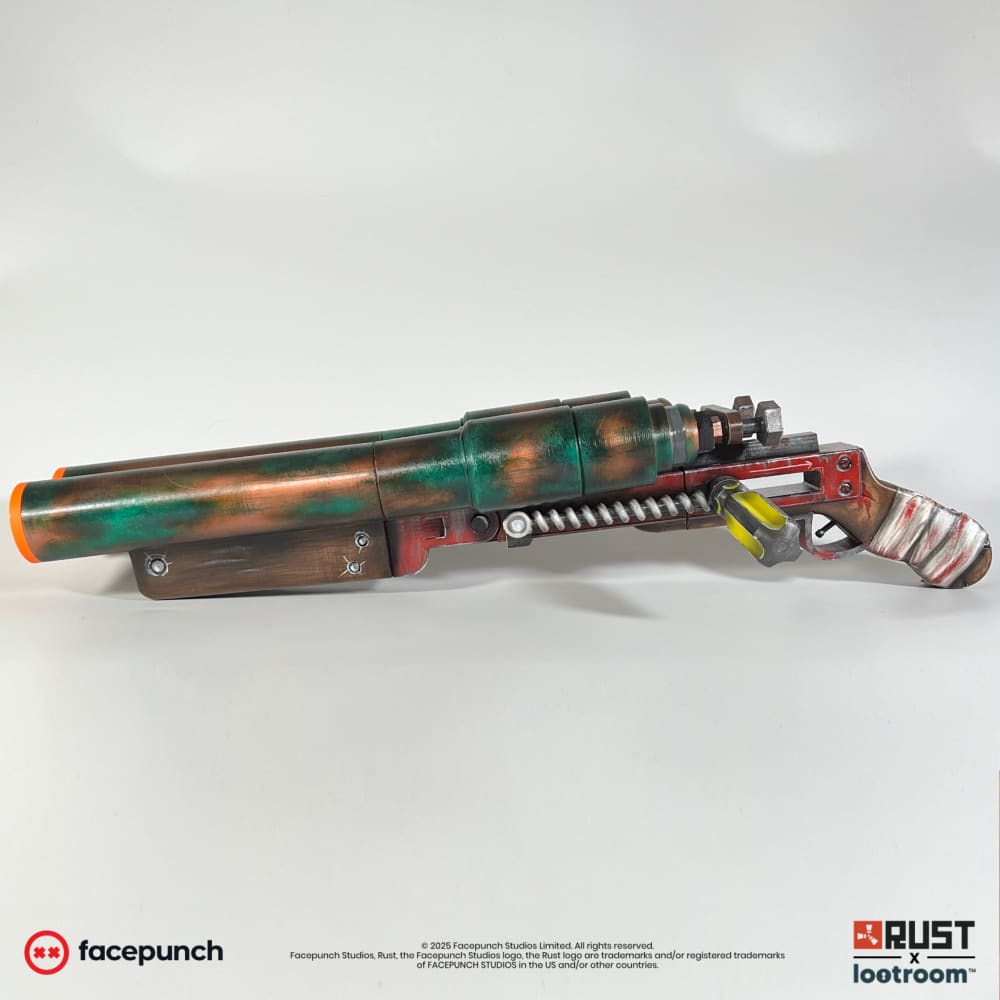Rust Double Barrel Shotgun prop replica seen at an angle, copper and green patina with red frame and yellow screwdriver lever