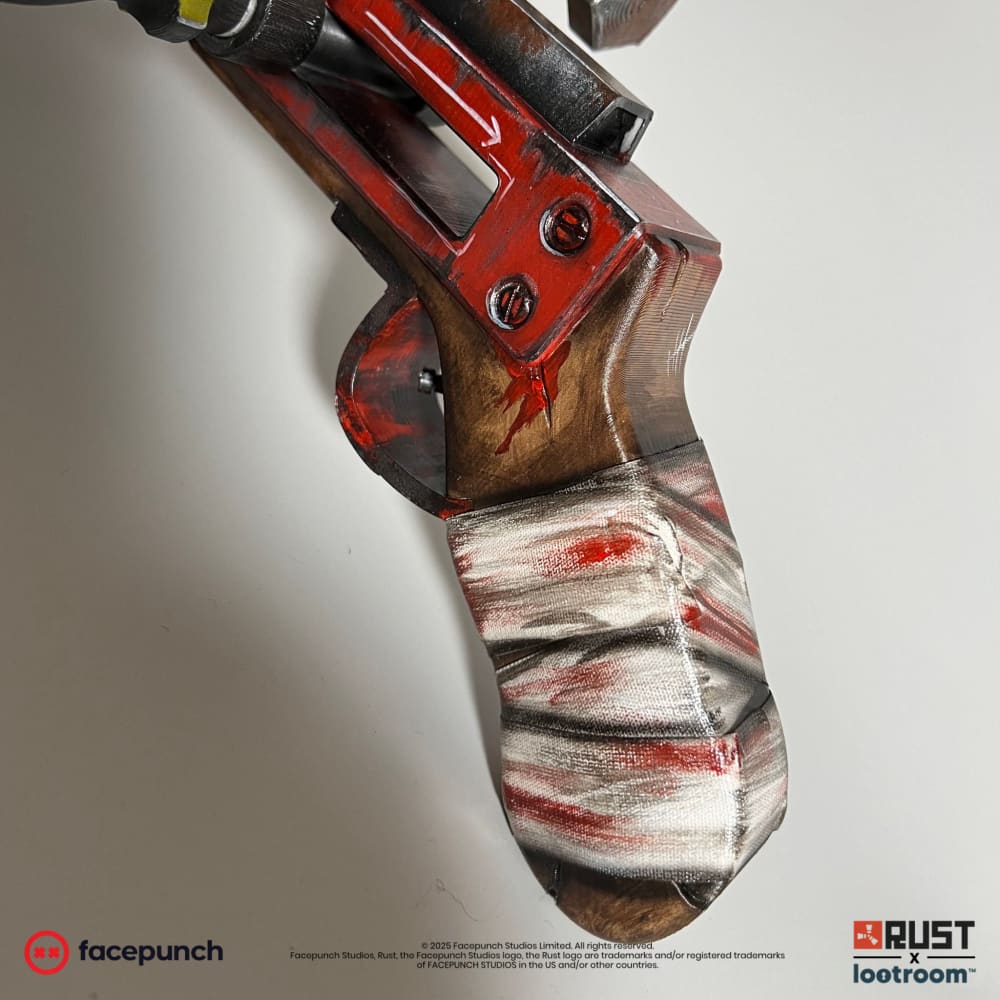 Close-up of the Double Barrel grip wrapped in a real blood-stained bandage over the wood-look handle
