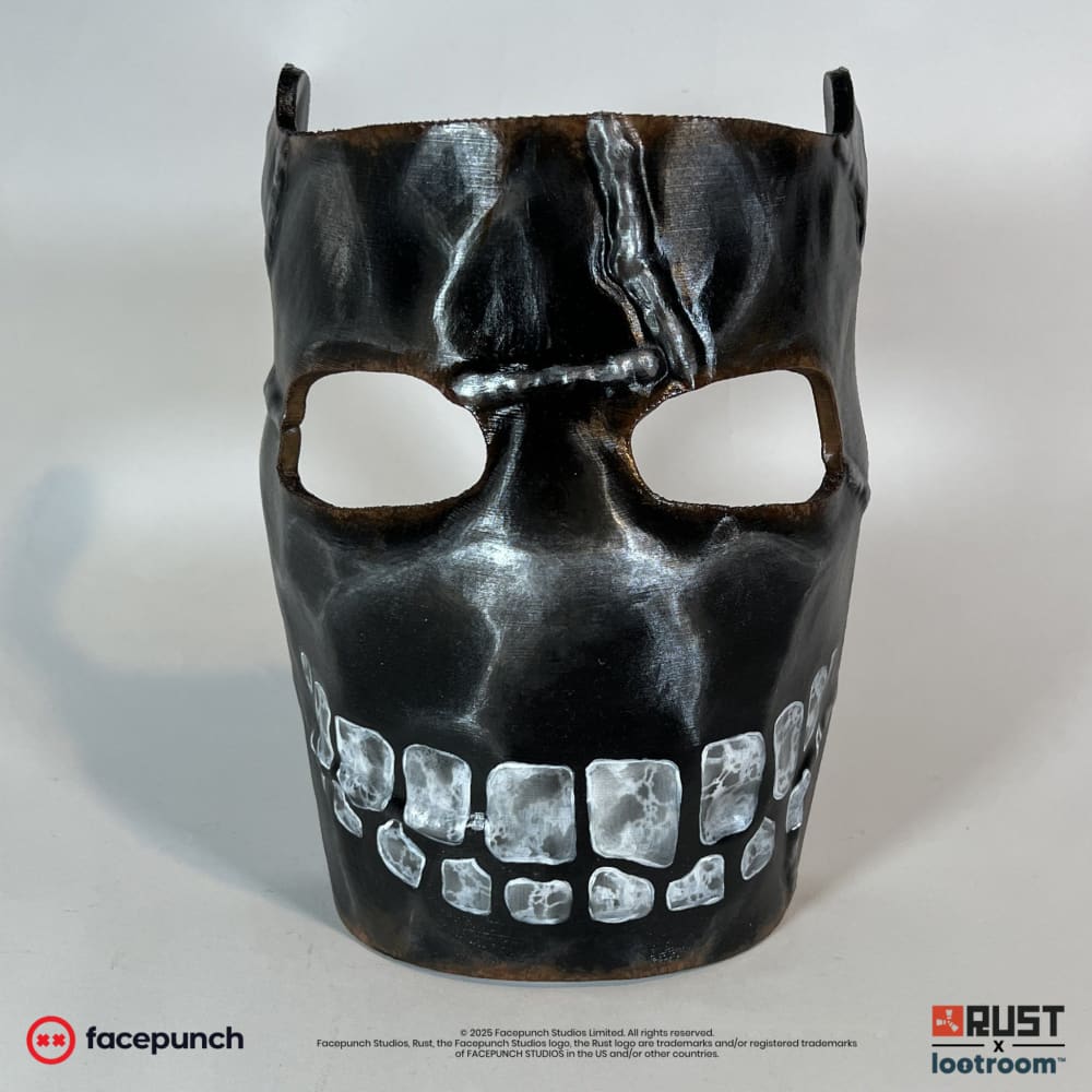 Rust Big Grin facemask from the front, blackened with rust-brown edges and a full grin of white painted teeth