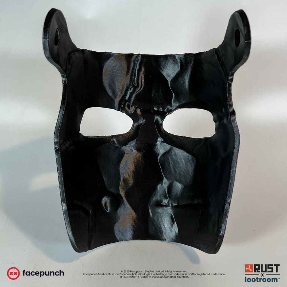 Inside of the Rust Big Grin facemask with its two eye openings and the two pre-drilled holes