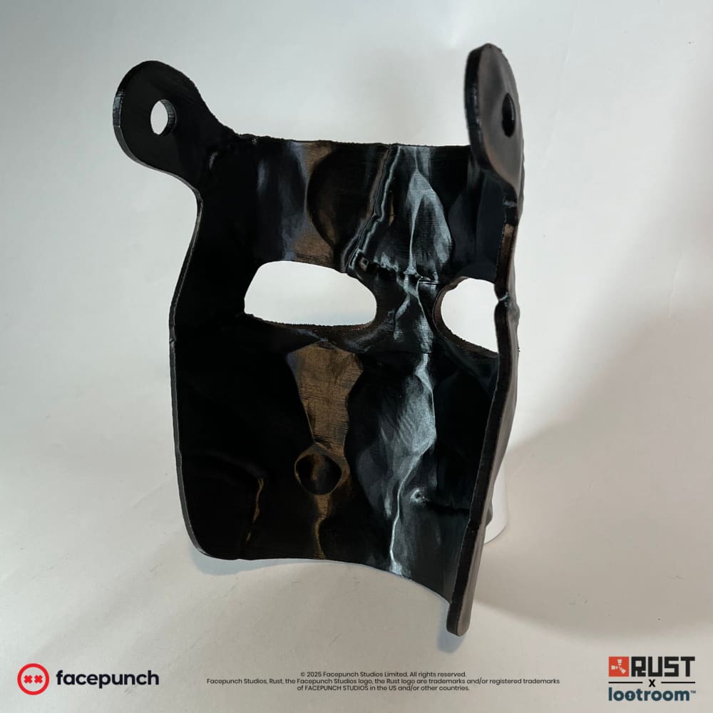 Rust Big Grin facemask seen from behind at an angle, with a pre-drilled hole on each side