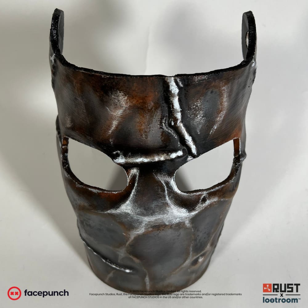 Rust Metal Facemask prop at a slight angle, weld seam running down the forehead
