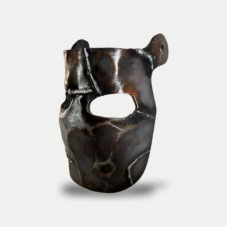 Rust Metal Facemask prop from the side, showing one of the two pre-drilled holes for the velcro strap