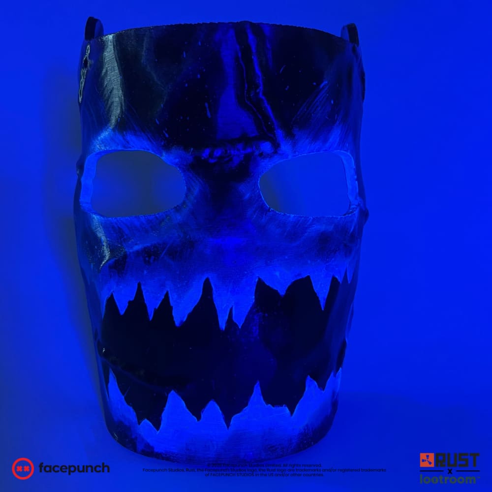 Rust Frostbite facemask prop under UV light, the blue frost glowing while the black mask goes dark