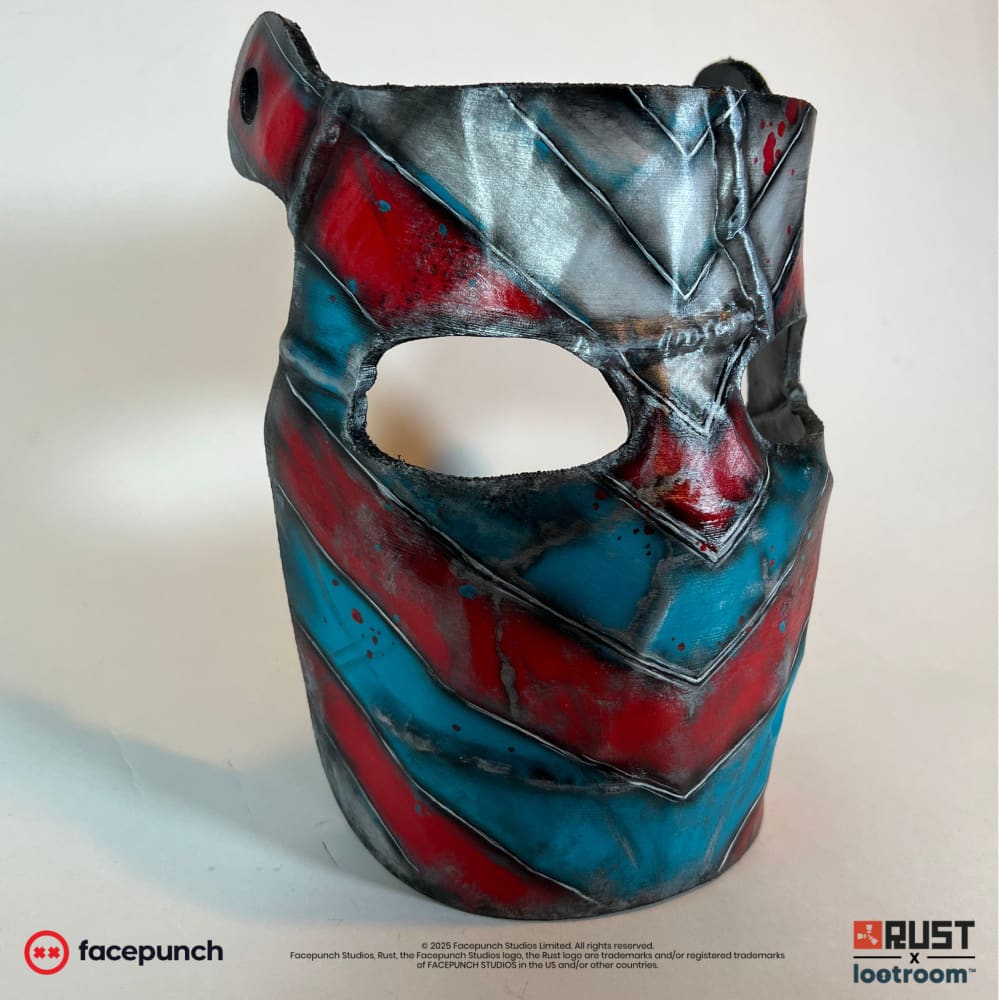 Rust IOK facemask prop at an angle, chevrons running round towards the back