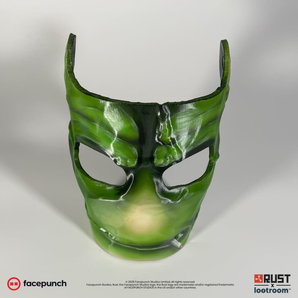 Rust StableRonaldo facemask prop, front view showing the two eye openings and the heavy frown
