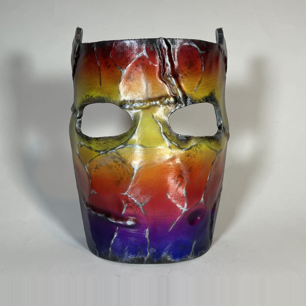 Rust Tempered facemask prop, front view of the red, gold and violet colours across the mask