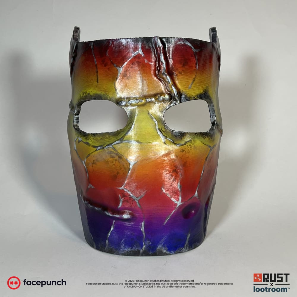Rust Tempered facemask prop, front view of the red, gold and violet colours across the mask