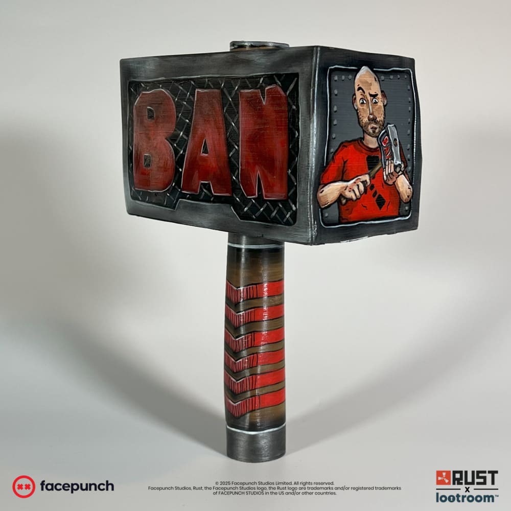 Rust Ban Hammer prop in the Camomo_10 skin, angled view with BAN in red on the head and the painted portrait on the narrow side.