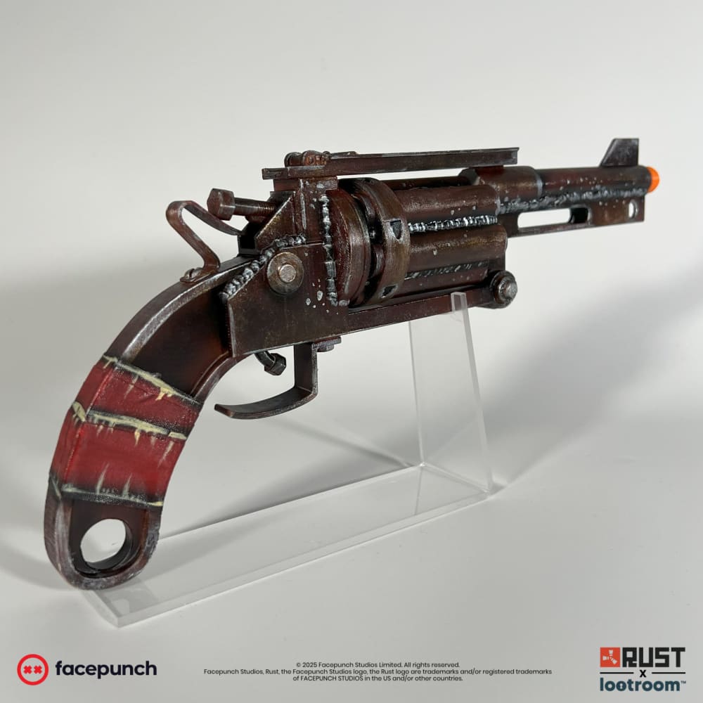 Rust High Caliber Revolver prop from behind, the red grip with its pale bands and the ring at the base