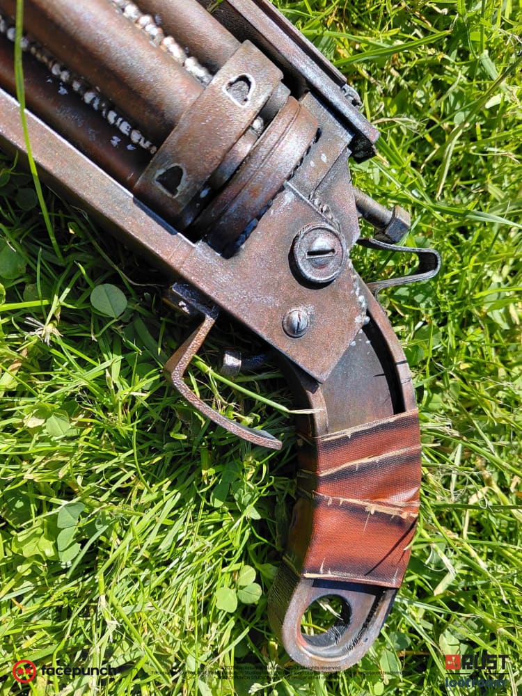 Close-up of the Rust High Caliber Revolver prop grip, real bands wrapped over the red paint