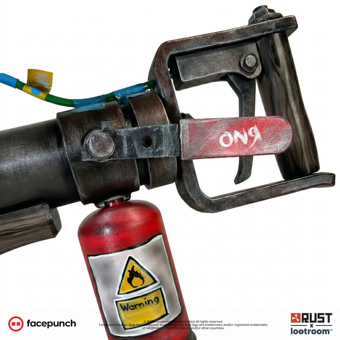 Close-up of the Rust Jackhammer handle with the painted warning label on the red fuel bottle