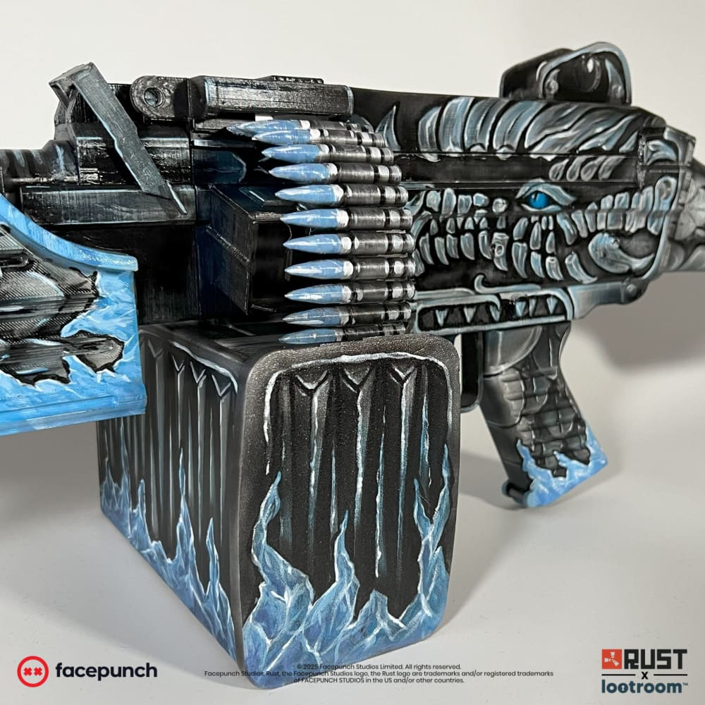 Close-up of the Frost M249 magazine box and ammo belt, printed rounds with ice-blue tips.