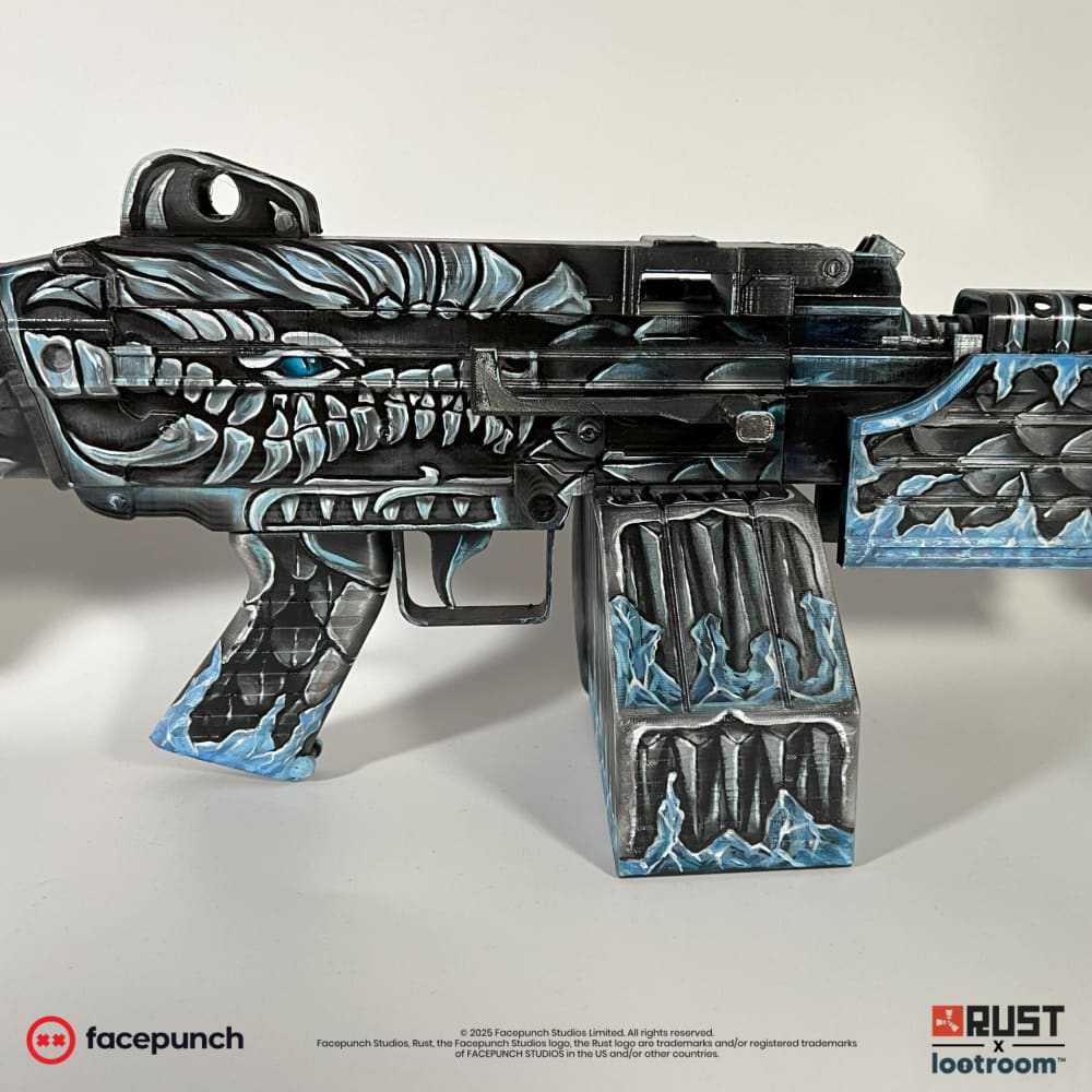 Side close-up of the Frost M249 receiver and grip, dragon scales running the full length.