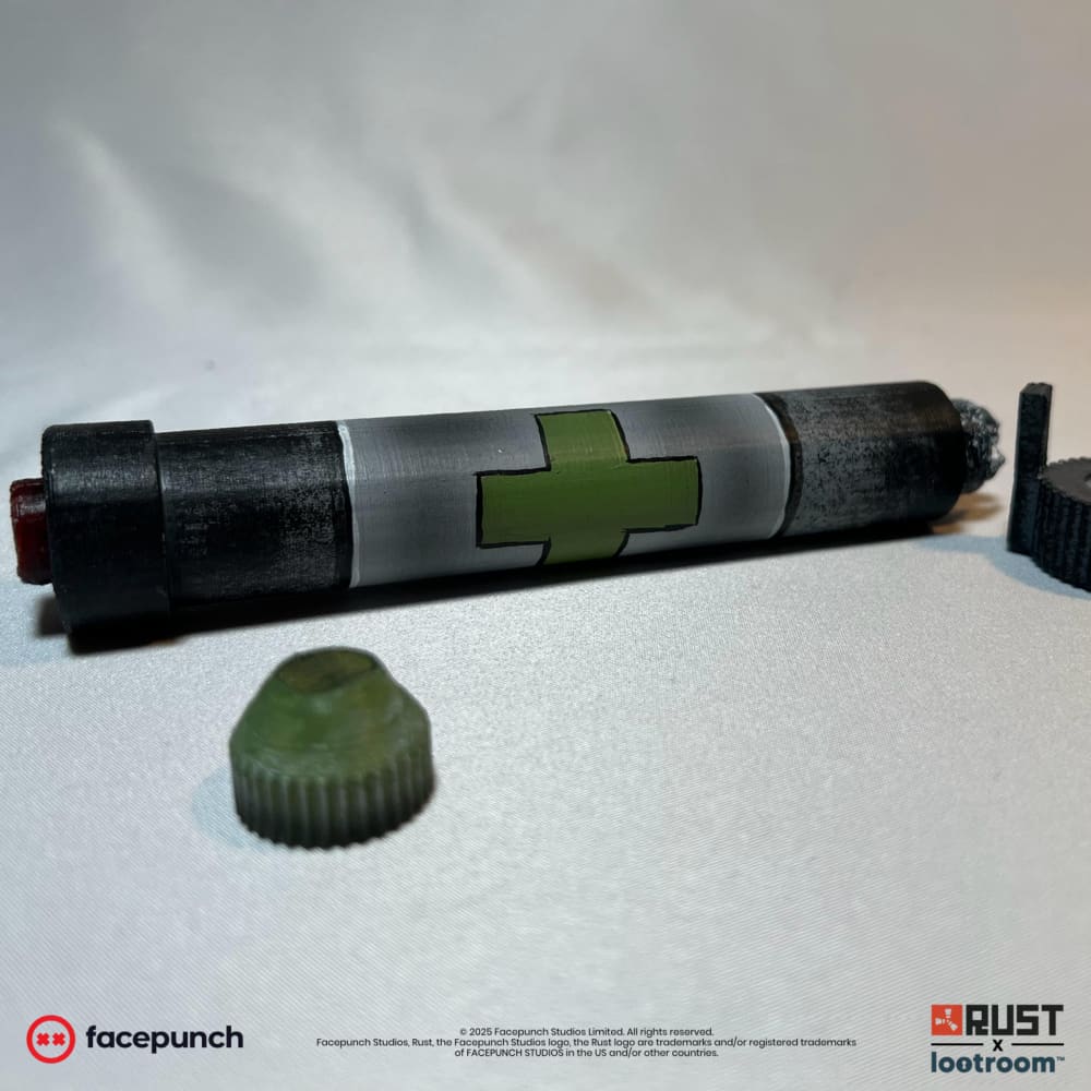 Close-up of the Rust Medpen lying down with the cap off, the red part showing at the end.